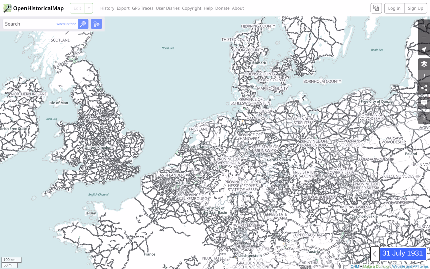 OpenHistoricalMap set to 13 July 1931 showing North-Western Europe. The UK, Germany and Benelux are very densely populated. France appears to be missing some routes. All railways are coloured in grey-black.
