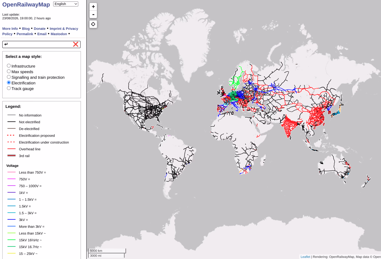 Screenshot of OpenRailwayMap, showing the whole world with the Electrification layer. The Americas, Africa and Oceania are mostly black (unelectrified), while Europe is a mix of red, blue and green (25 kV AC, 3 kV DC and 15 kV DC), and China and India are almost all red.